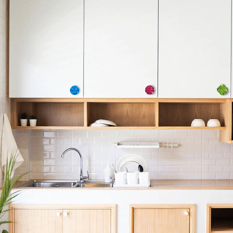 Four Piece Door Knob Molds For Epoxy Resin in kitchen, colorful polygonal knobs on white cabinets.