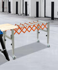 Super Flex Adjustable Telescopic Conveyor Roller Table With Integrated Scale Display And Secure Hooks For Moving Heavy Loads From 18 To 51 Inches Long And 17 Wide in workshop setting.