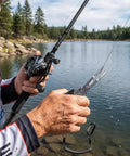 Using 2 Pack Stainless Steel Fishing Pliers With Lanyard, Needle Nose Hook Remover Set near a lake.
