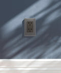 Dang Sturdy Stainless Steel Wall Outlet Cover Plate With Six Round Holes And Heavy Duty Metal Shield mounted on a blue wall.