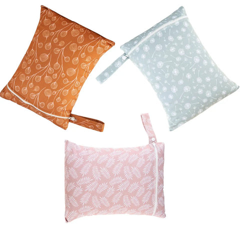 Three Piece Waterproof Wet Bag Storage Set for Baby and Travel in orange, blue, and pink floral patterns.