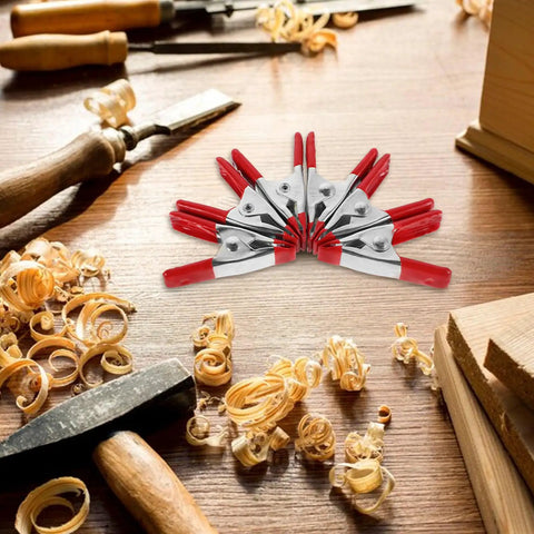 Super Sturdy 12 Piece Heavy Duty Metal Spring Clamps With Red Coated Jaws, Perfect For Woodworking Crafts Panel Fixing And DIY Household Projects That Rock. 12 metal clamps on woodwork bench
