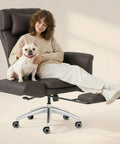Woman sitting on oversized chaise lounge chair with wheels and footrest, ultra comfy big seat for living room, scratch resistant