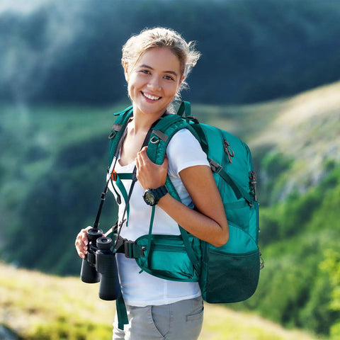 Person wearing 40L Waterproof Hiking Backpack For Outdoor Adventures Go To Ultra Lightweight Daypack in green while hiking in nature.