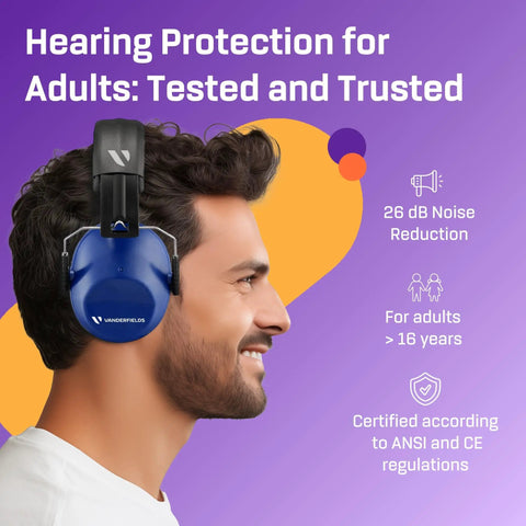 Side view of a man wearing heavy duty hearing protection ear muffs with 26 dB noise reduction; ANSI and CE certified.