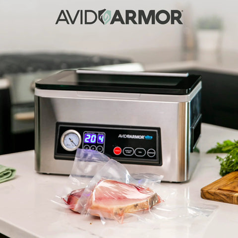 Front view of Avid Armor chamber vacuum sealer stainless steel with 11.5-in seal bar and digital controls, meat in bag