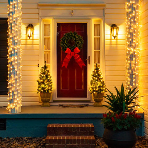 Front porch lit by warm white 300 LED Christmas string lights with clear wire for indoor outdoor use waterproof eight modes including chase effects