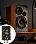 Pro Grade Heavy Duty Filter Capacitor Selection Featuring 10UF Through 100UF Picks For Industrial Power Conversion And Hifi Rectification With Rock Solid 500V Ratings And Built Tough Resilience For Hands On Makers in front of a speaker.