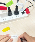 60 Piece Color Coded Cable Labels And Hook And Loop Ties Set For Home Office, applied on cords with handwritten labels.