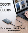 2TB Portable SSD SL500 USB 3.2 Gen 2x2 connected to laptop showing high-speed data transfer