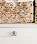 Smooth And Stylish Satin Nickel Mushroom Cabinet Knobs For No Sweat Hardware Swaps And Instant Kitchen Glow Ups That Fit Perfectly On Drawers Cupboards And Desk Surfaces on white drawer next to woven baskets.