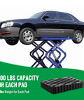 Racewill 4-pack solid rubber auto lift pads for car lifts; black textured blocks on a scissor lift, side view