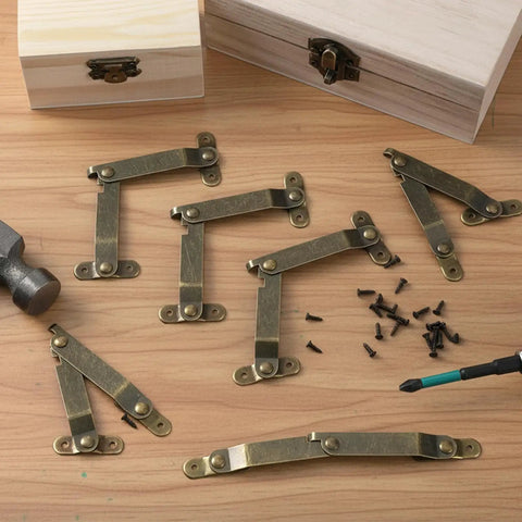 Six Piece Antique Brass Lid Support Folding Hinges For Jewelry Boxes And Wooden Cabinets with screws on a wooden table