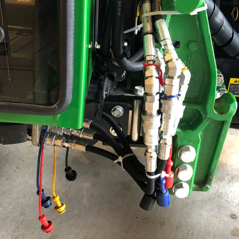 ISO 5675 Pioneer-style 1/4 in hydraulic quick-connect couplers with 1/4 in NPT threads, mounted on green unit