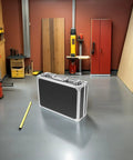 Portable Aluminum Tool Box With Lightweight Alloy Construction shown in a workshop near red cabinet and wooden boards
