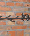 Vintage Cast Iron Tree Branch Coat Hook For Walls And Entryways Bringing Dope Rustic Vibes And Straightforward Storage Solutions That Honestly Upgrade Your Home Decor Setup mounted on brick wall with two bird accents.