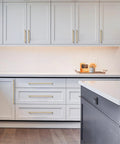 Champagne Bronze Cabinet Pulls 10 Pack 5 Inch Center To Center 128mm installed on white kitchen cabinets and drawers.