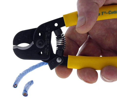 Hella Versatile Data T Cutter Wire Tool For Structured Networks And Coax Cables Up To Rg 11 held in hand, cutting blue coax cables.