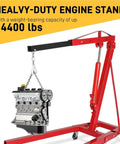 Badass 2 Ton Hydraulic Engine Hoist 4000 Lb Capacity Folding Cherry Picker lifting an engine with chain, heavy duty red steel frame.