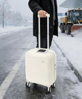 Mint Blue And Pearl White 18 Inch Carry On Suitcase With A Built In USB Charging Port And Roomy Power Bank Pocket For Traveling in snowy setting.