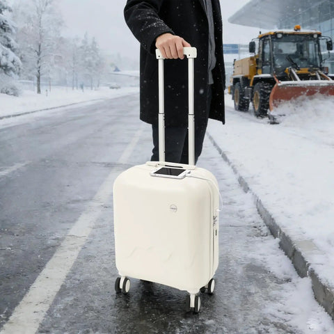 Mint Blue And Pearl White 18 Inch Carry On Suitcase With A Built In USB Charging Port And Roomy Power Bank Pocket For Traveling in snowy setting.