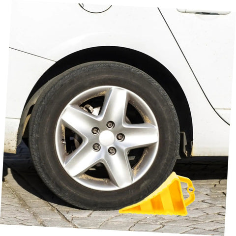 2 Pack Heavy Duty Rubber Wheel Chocks positioned under a car tire, showcasing sturdy hoist handles and grit treads.