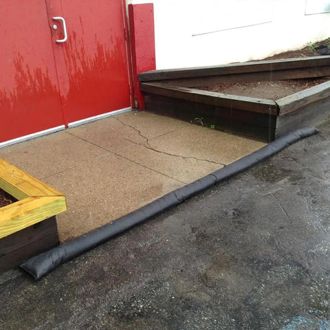 Water Activated Flood Barrier 5 Feet Pack Black at door, expands to 3.5 inches in minutes for flood control, flexible design.