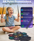 Girl playing Portable Roll Up Electric Drum Kit With 9 Pads And Dual Stereo Speakers Bluetooth MIDI Practice Ready For Kids And Adults Beginners Includes Pedals Sticks And Headphone Support, smiling with headphones and sticks.