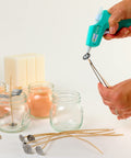 Hands using Clear Mini Hot Glue Sticks 4 Inch, 550 Count, All Temp Bonding for Crafting with mini glue gun and candle jars