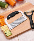 Nur Essentials two-piece crinkle cutter and waffle fry cutter set with peeler; stainless steel blades and black handles.