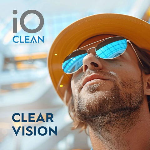 iO CLEAN eyeglass lens cleaner kit logo visible; man wearing yellow hat and mirrored blue sunglasses