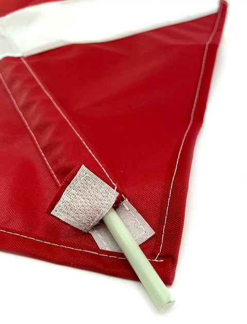Close-up of red dive flag for scuba and spearfishing with float or buoy and pole, 14 by 16 inch, showing removable fiberglass stiffener.