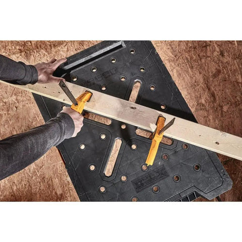 Express Folding Workbench With Quick Setup In Under 3 Seconds Beefy 1000 Lbs Metal Legs Large Work Surface in use, trigger clamps holding wood