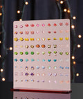 Front view of Rose Gold Mirror Finish Acrylic Earring Stand Three Pack Set with colorful earrings, showcasing 90 holes.