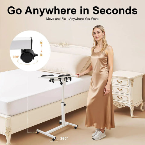 Adjustable Height Rolling Standing Desk With Locked Down Casters And Swivel Surface Lightweight Mobile Laptop Table For Home Office Over Bed No Sweat Assembly Slick White Finish next to a bed.