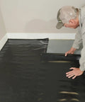 Rock Solid.006 Mil Polyethylene Moisture Vapor Barrier Roll For Laminate Engineered Hardwood Floors 100 Square Feet laid out during installation.