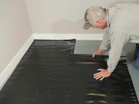 Rock Solid.006 Mil Polyethylene Moisture Vapor Barrier Roll For Laminate Engineered Hardwood Floors 100 Square Feet laid out during installation.
