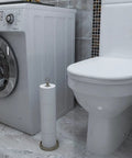 Heavy Duty Free Standing Toilet Paper Holder With Reserve Function, Brushed Nickel, next to a toilet and washing machine in bathroom