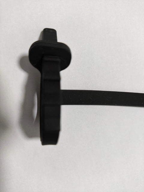 Keep Your Rig Running Smooth With This Hella Reliable EV Charger Plug Port Cover featuring a quick zip tie mount in black rubber.