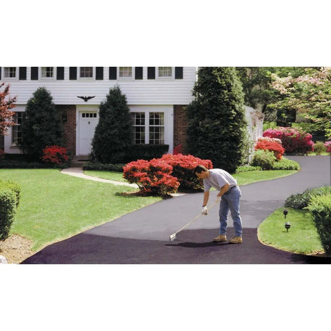 Person applying EZ Stir Rubber Driveway Asphalt Filler Sealer For Cracks Up To One Eighth Inch Quick Patch For Blacktop on driveway