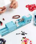 Compact Mini Wood Lathe And Milling Machine For Engraving Sanding Cutting Multi Purpose Tabletop Tool with beads and tools on a workspace.