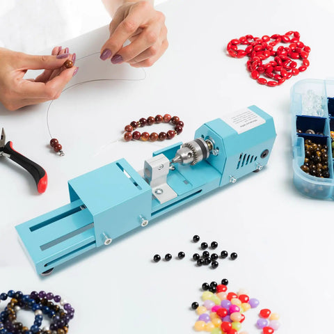 Compact Mini Wood Lathe And Milling Machine For Engraving Sanding Cutting Multi Purpose Tabletop Tool with beads and tools on a workspace.