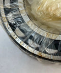 22216 Spherical Roller Bearing With 80mm Inner Diameter and 140mm Outer Diameter Measuring 33mm Wide, wrapped in plastic.