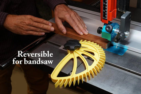 Yellow Hedgehog featherboard for table saws with black knob, mounted on the saw beside a wood workpiece