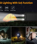 Solar Power Bank 20,000mAh Portable Charger On The Go LED lighting near tent, highlighting outdoor night use.