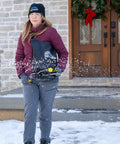 Person using Spyker 25Lb Bag Spreader With Material Viewing Window And Easy Calibration System in snowy outdoor setting.