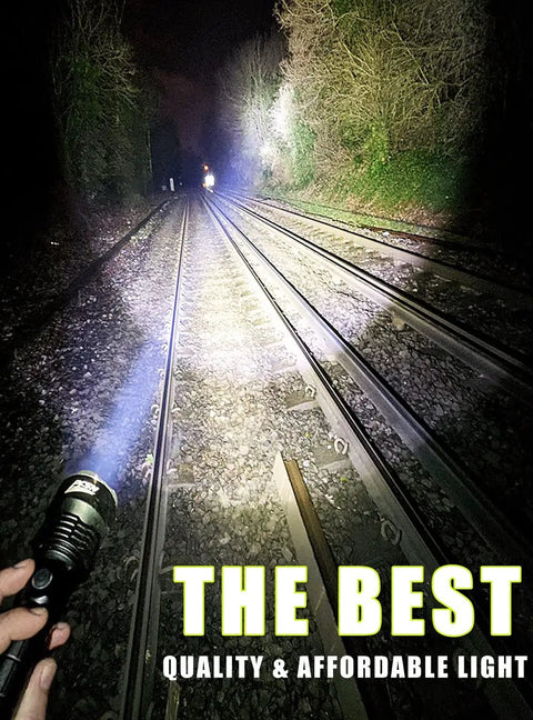 Using 6000 Lumen Rechargeable Waterproof Flashlight With P50 LED on train tracks at night, powerful beam visible, durable build.