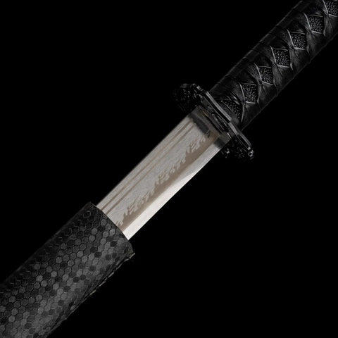 Close-up of Real Carbon Steel Katana for Iaido Practice and Display, showing unsharpened blade and full tang samurai sword handle.