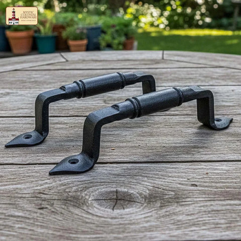 Mystic Colonial Rustic Cast Iron Barn Door Handles Set Of 2 In Black Finish on wooden table, ideal for gates and garden doors.