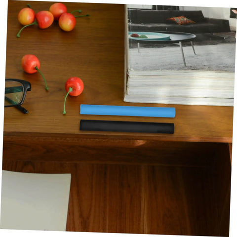 Two Six Pack Wood Repair Wax Filler Sticks on wooden table next to glasses and cherries, for quick DIY scratch and hole fix.